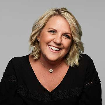 Color photo of woman, Meredith, shoulder up, smiling for camera.