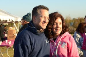 Dr. Ron Israeli stands with a woman in a pink sweatshirt at Making Strides of Long Island 2012