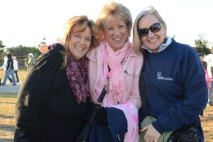 Three women smiling for camera at Making Strides of Long Island 2012