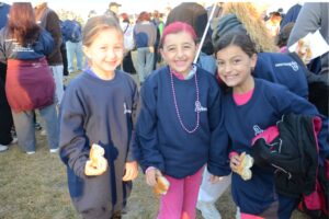 Three young girls pose, one of whom has pink hair, pose at Making Strides of Long Island 2012