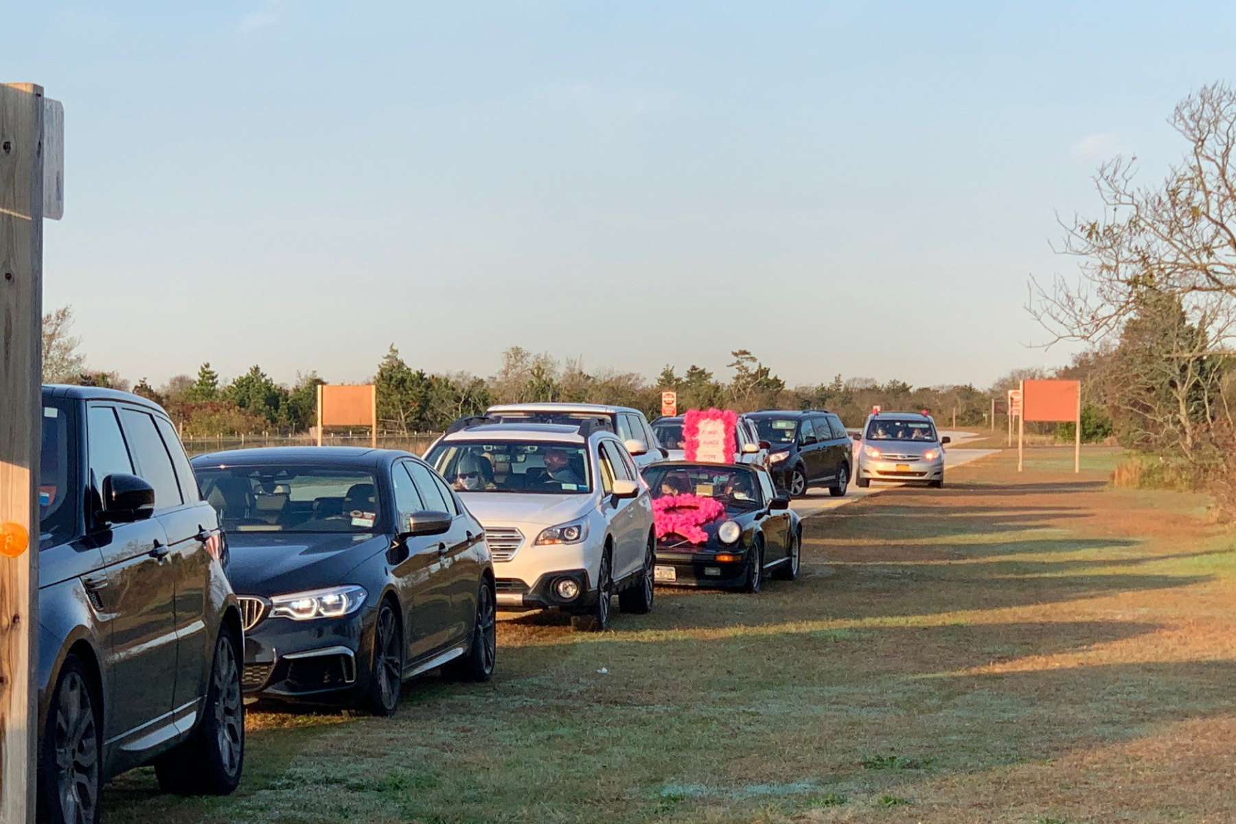 View of the front of the line of NYBRA team cars with sun rising in the background at the Making Strides 2020 Drive Through Experience at Jones Beach.