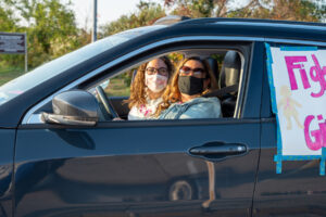 Two people with masks on in car atMaking Strides 2020 Drive Through photo