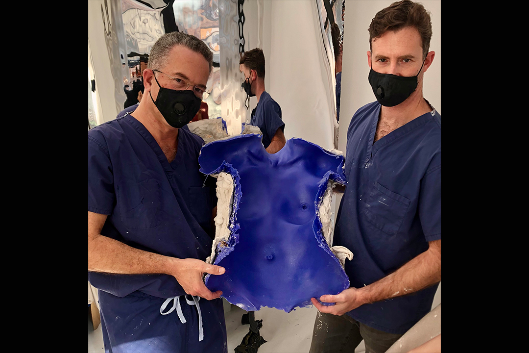 Dr. Israeli and Dr. Bank hold a completed molding of life cast and looking at camera.