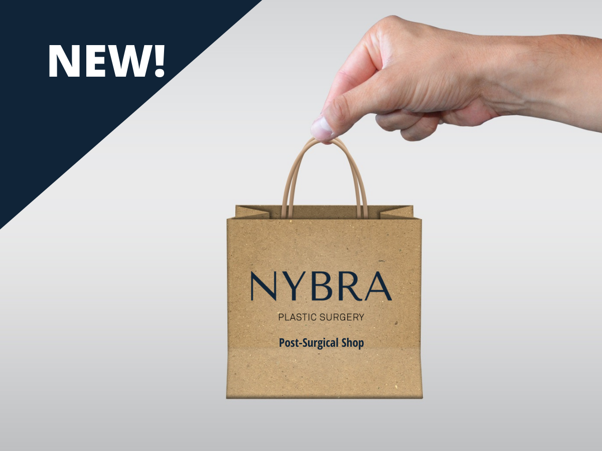 Photo of woman holding tiniest brown shopping bag with NYBRA Plastic Surgery Post-Surgical Shop on it.