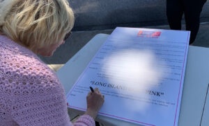 Photo of NYBRA signing the proclamation at the Go Pink Long Island event to kick off Breast Cancer Awareness Month on Oct. 1, 2021