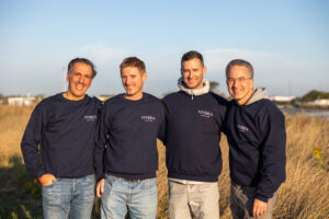 Doctors David Light, Peter Korn, Jonathan Bank, and Ron Israeli stand posed with their arms over each other's shoulders.
