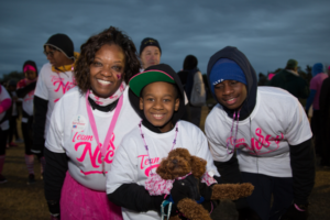 Family of three smiling at Making Strides of Long Island 2018