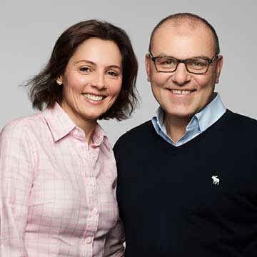 Color photo of woman and man, Sabine and husband, posing for camera.