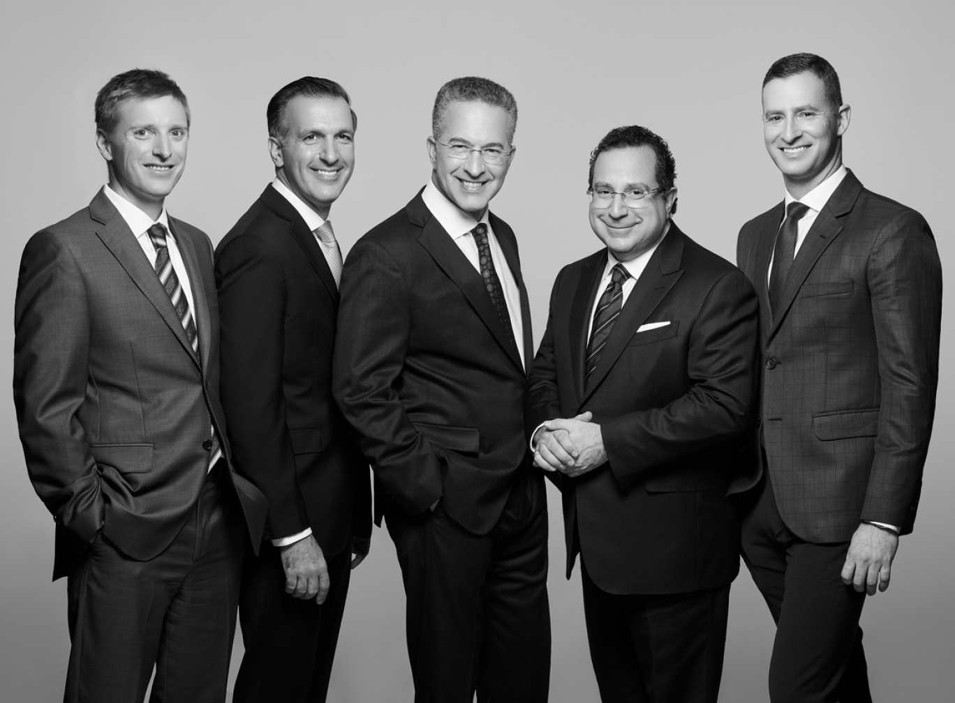 The 5 NYBRA doctors stand posing in black and white photo smiling. Left to right from top to bottom: Randall S. Feingold, M.D., Ron Israeli, M.D., Peter T. Korn, M.D., David M. Light, M.D., Jonathan Bank, M.D.,