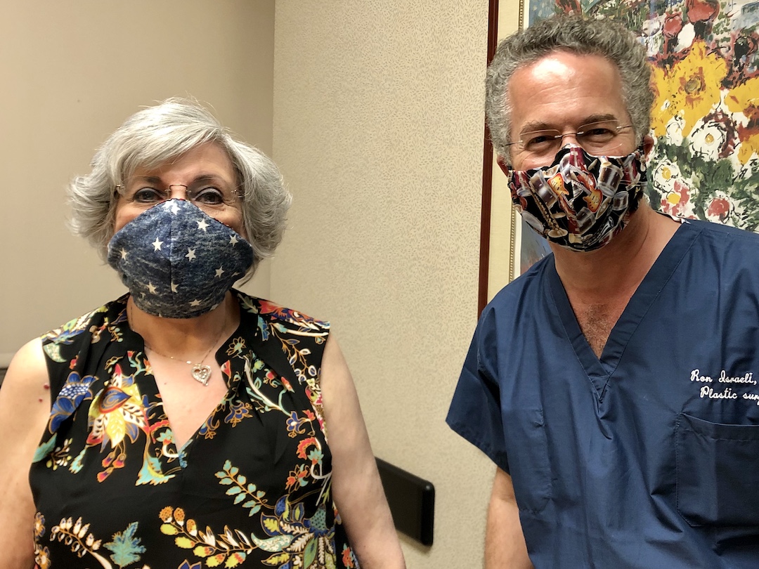 Color photo of Angela and Dr. Israeli, wearing masks and looking directly at camera.