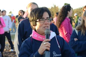 A woman speaks into a microphone at Making Strides of Long Island 2012