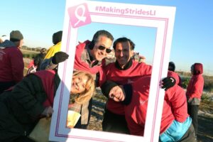 NYBRA team hold up Strides Photo Sign at Making Strides of Long Island 2015