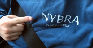 Finger pointing to NYBRA logo on blue sweatshirt atMaking Strides 2020 Drive Through photo