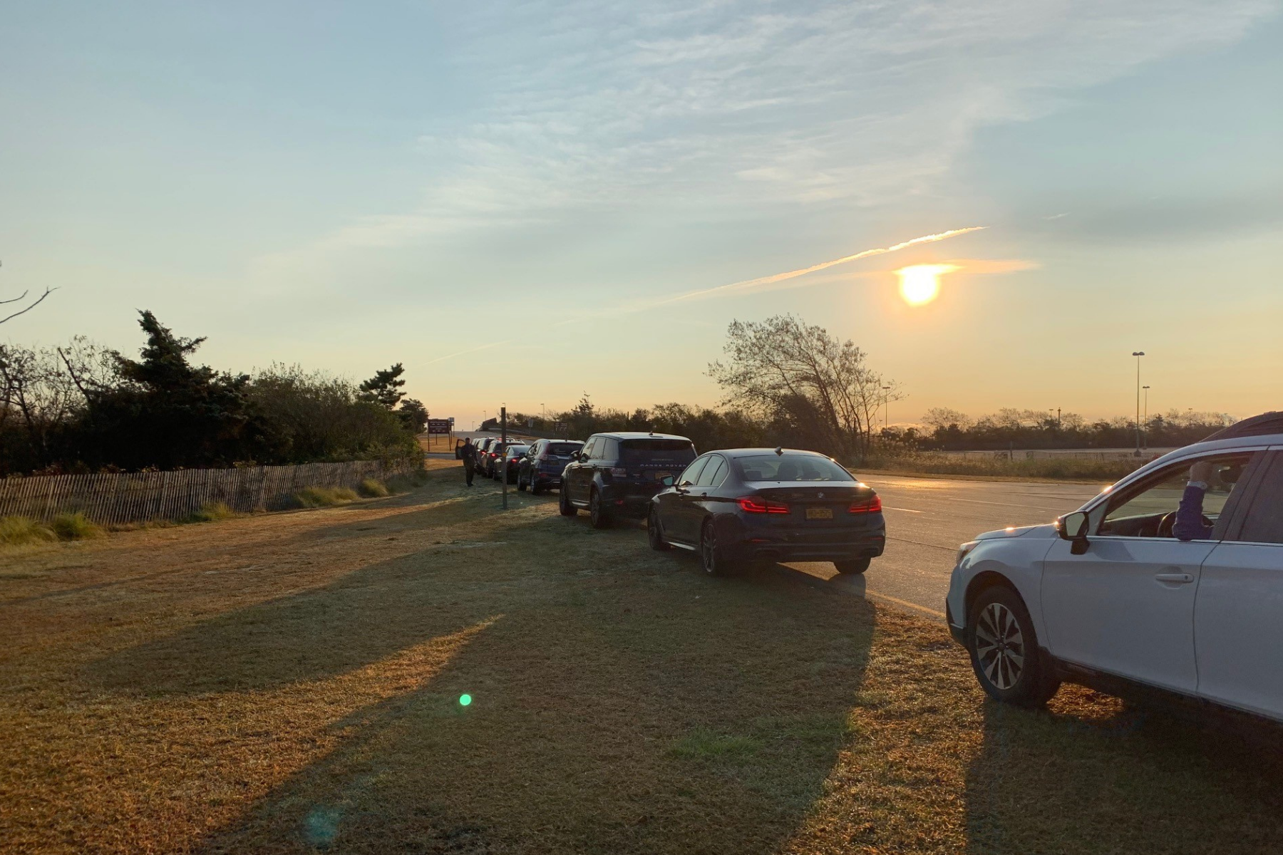 View of the line of NYBRA team cars with sun rising in the background at the Making Strides 2020 Drive Through Experience at Jones Beach.