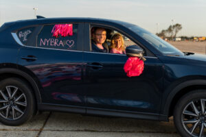 Couple smiling from car at Making Strides 2020 Drive Through photo