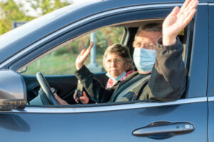Two people waving from car at Making Strides 2020 Drive Through photo