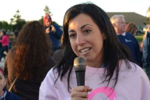 A woman speaks into a microphone at Making Strides of Long Island 2012