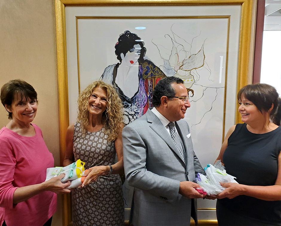Jackie's Angels present Dr. Feingold and Mollie with shower drain holders.