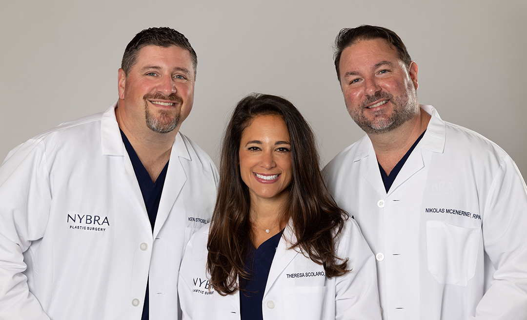 Color photo of 2 men and 1 women smiling for camera